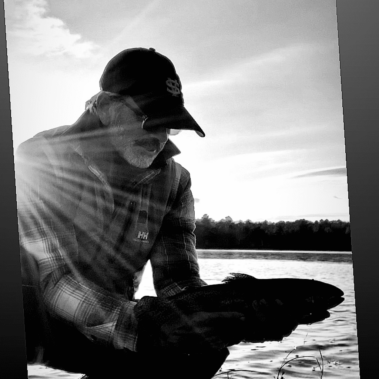 Dan with a fish on the lake