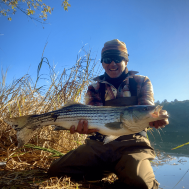 Dan with a fish he caught by the lake