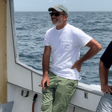 Dan on a boat with a cigar