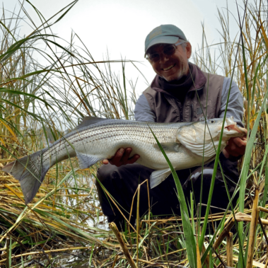 Dan with a fish in the grass