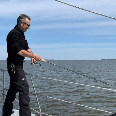 Dan fishing on a boat